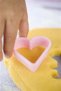 Child cutting out biscuits