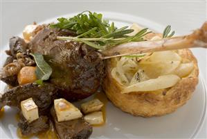 Braised goose leg with pear and onion tart
