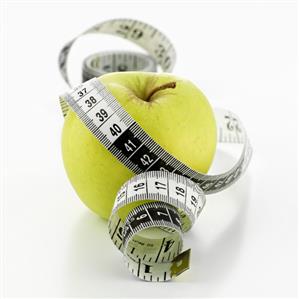 Green apple with tape measure