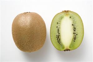 Whole kiwi fruit & half a kiwi fruit (longitudinal section)