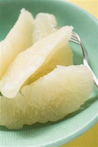 Grapefruit segments on plate with fork