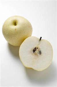 Whole Nashi pear and half a Nashi pear (overhead view)