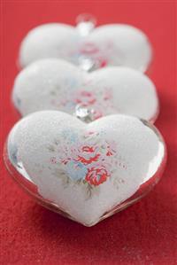 Three silver hearts with rose motifs (Xmas tree ornaments)