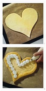 Making heart-shaped cake with cream border