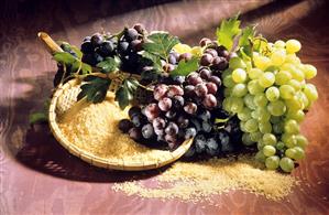 Still life with white & red wine grapes & a bowl of rice