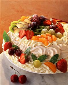 Meringue gateau with cream and fresh fruit