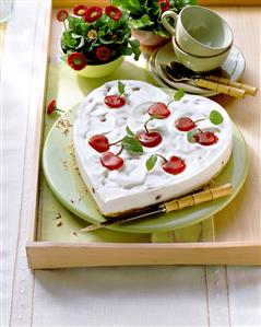 Heart-shaped yoghurt cherry cheesecake, with glace cherries