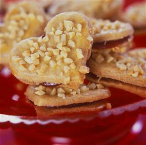 Almond hearts with jam filling on baking sheet