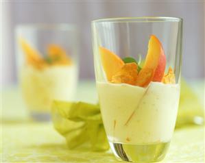 Mango yoghurt with cashew kernels and cornflakes