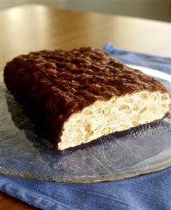 White nougat with nuts and chocolate coating