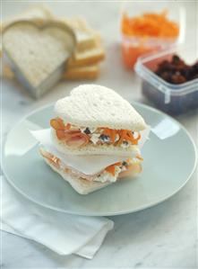 Heart-shaped ham and cheese sandwiches with strips of carrot