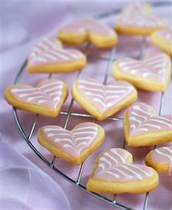 Decorated sweet pastry hearts on a rack