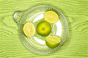 Limes in citrus squeezer