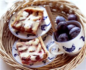 Plum cake with quark and fresh plums on tray