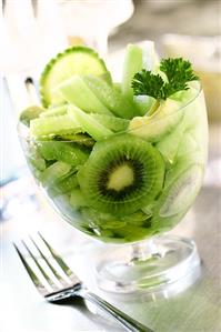 Green salad of kiwi fruits, cucumber and avocados