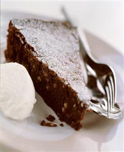 A piece of chocolate pine nut cake with white mousse