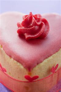 Small heart-shaped cake with pink icing