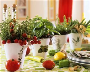 Bunch of thyme and basil with lemons and tomatoes