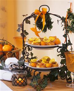 Baguette with salmon snacks and kumquats on tiered metal stand
