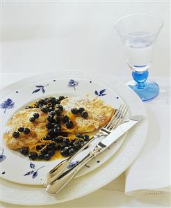 Apple fritters with blueberry and orange sauce