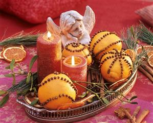 Oranges studded with cloves, candles and an angel