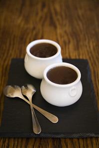 Hot chocolate in two pots with spoons