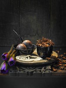 Still life: star anise with passion fruit, beads & flowers