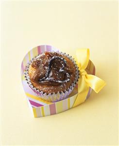 Banana cupcake with dulce de leche topping in heart-shaped box