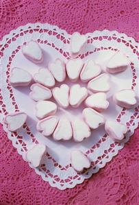 Heart-shaped marshmallows on a heart-shaped paper doily