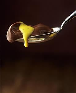 Chocolate cream with saffron sauce on spoon