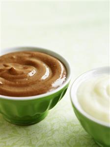 Chocolate dessert and vanilla dessert in two bowls