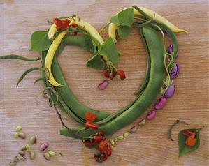 Yellow and green beans with flowers, forming a heart