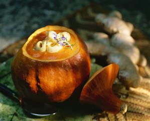 Cream of pumpkin soup in hollowed-out pumpkin