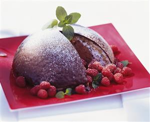 Chocolate ice cream bombe with fresh raspberries