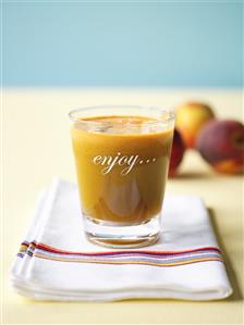 A glass of apple and peach juice
