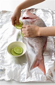 Stuffing a fish with lime slices