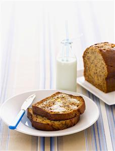 Banana & honey bread, two slices buttered, bottle of milk