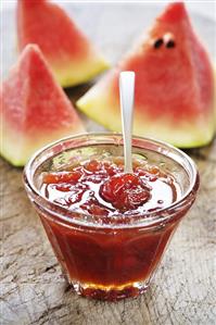 Watermelon jam in glass dish with spoon