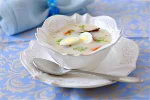 Sour flour soup with boiled eggs and sausage