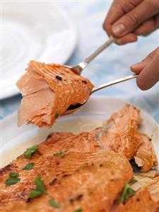 Serving salmon fillet with orange, maple syrup & ginger glaze