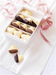 Chocolate-dipped shortbread hearts in a box