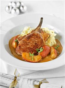Pork chop with apple wedges and mashed potato