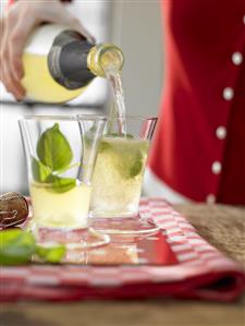 Lemon cocktail made with limoncello, basil & sparkling wine