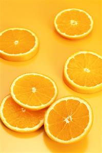 Several orange slices on orange background