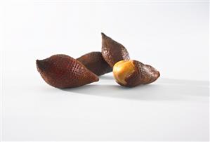 Salak fruit, one partly peeled