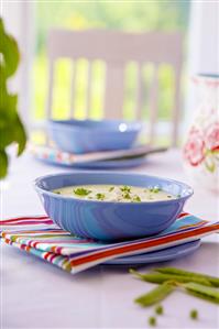 Cheese soup in two blue bowls