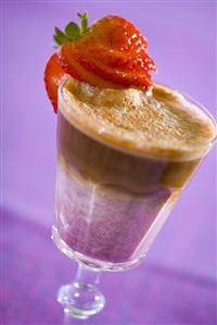 Espresso with strawberry syrup and milk in a glass