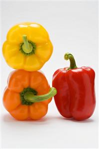 Three peppers, two stacked, one standing