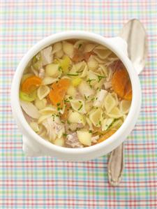 Chicken soup with pasta and carrots (overhead view)