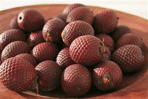 Fruit of the Moriche palm (Mauritia flexuosa) in a dish